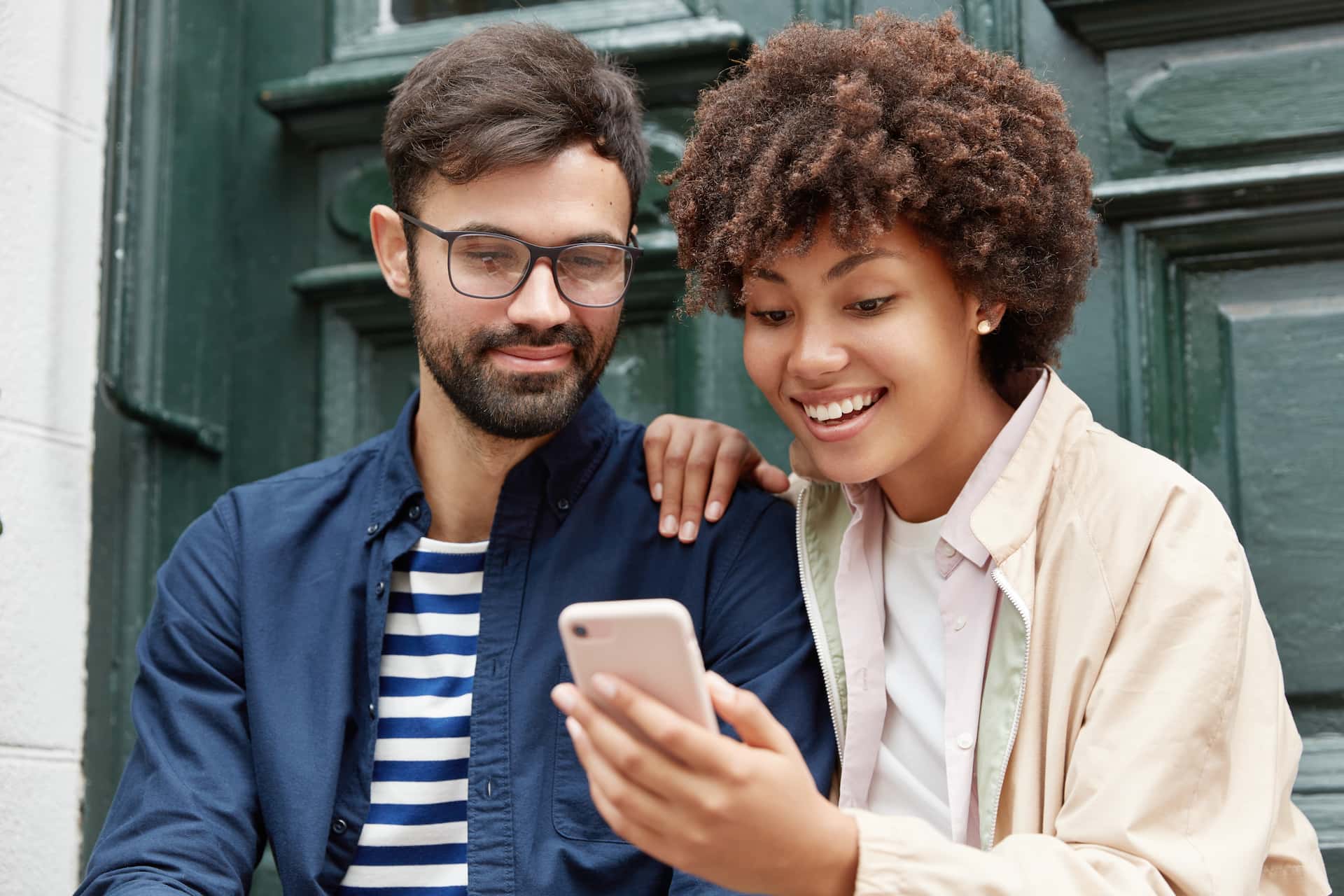 Friends using a phone to find a nearby event
